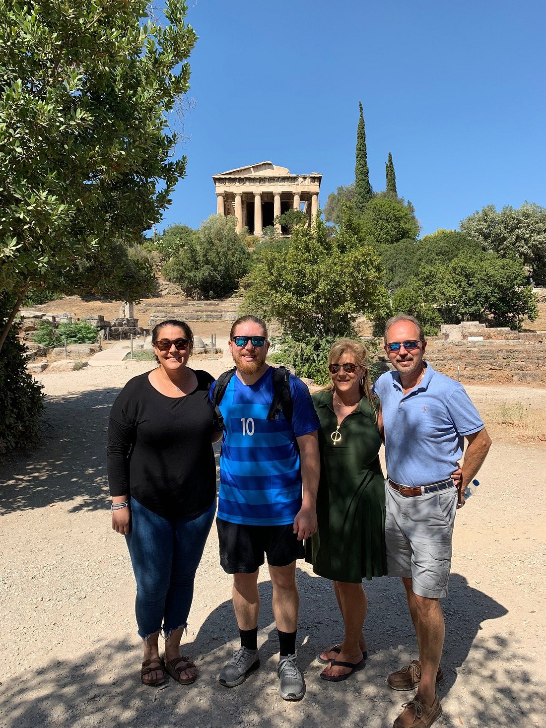 two couples posing in front of the temple of hephestus in agora