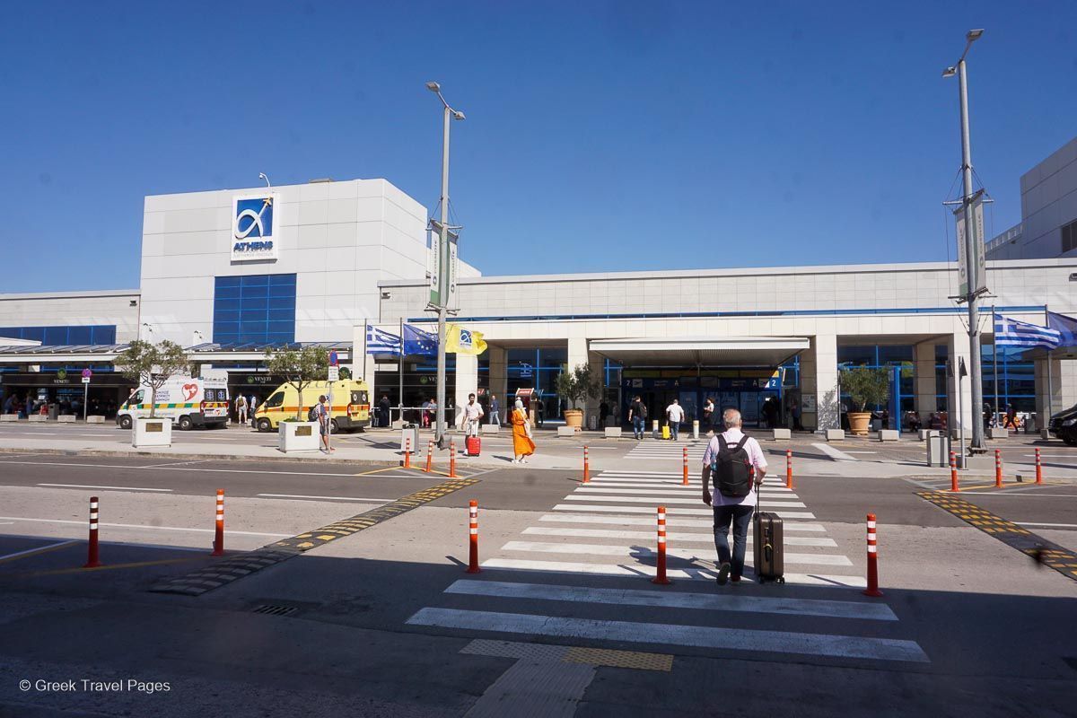 entrance at the Athens airport with some people walking