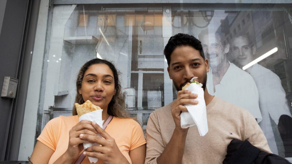 a couple eats at kostas souvlaki in philelinon street